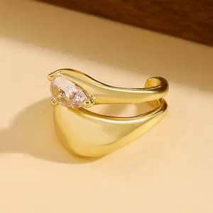Macro view of a luxury water-drop cubic zirconia ear cuff with gold twisted lines