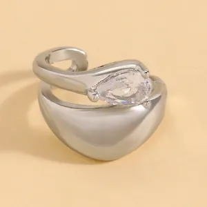 Detailed macro view of twisted silver ear cuff with a pear-shaped sparkling zircon