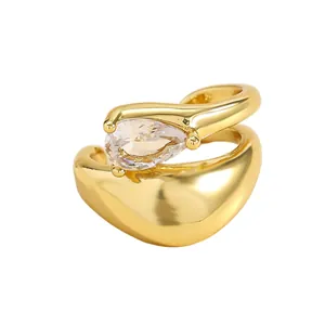 Detailed view of luxury golden twisted ear cuff set with a pear-cut clear zircon stone