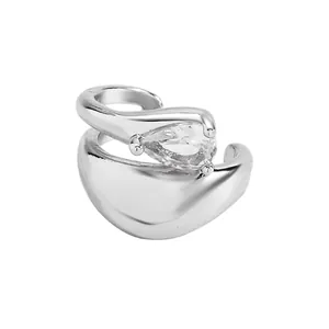 Detail view of a silver-toned ear cuff featuring a pear-cut clear zircon stone.