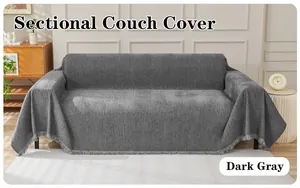 Dark gray chenille sectional couch cover, soft draped sofa slipcover with fringe details.