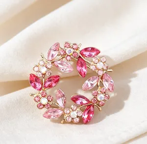 Detailed macro view of an elegant vintage pink crystal floral wreath brooch accessory