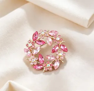 Detailed view of elegant vintage flower wreath brooch featuring sparkling pink crystals
