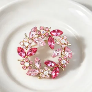 Elegant vintage crystal wreath brooch featuring pink and magenta rhinestones for women