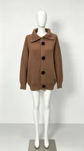 Front view of an oversized brown knitted cardigan with a large lapel and black buttons