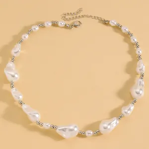 Close-up view of an elegant baroque irregular pearl necklace with silver-tone beads.
