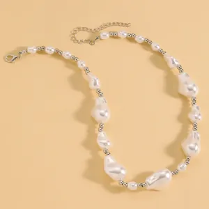 Detailed view of an elegant baroque irregular pearl necklace with metallic silver beads