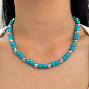 Bohemian style turquoise beaded necklace featuring silver metallic accents on a neck