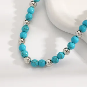 Detailed close-up view of turquoise and silver beaded necklace with Bohemian style.