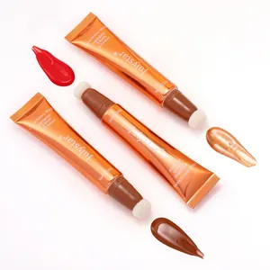 Detail view of makeup wands featuring sponge tips and liquid swatches in diverse shades