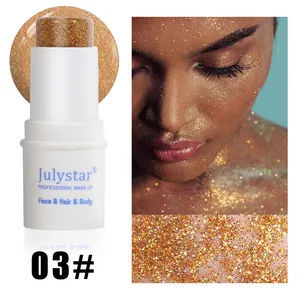 Close-up of golden glitter makeup stick with skin application and texture detail