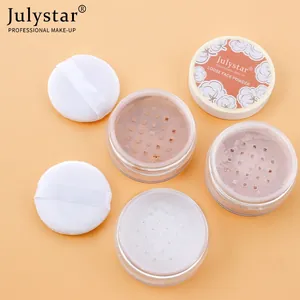 Macro view of three Julystar matte loose powder jars with soft white makeup puffs