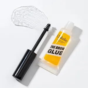 Detailed view of clear eyebrow styling glue with applicator brush on white background