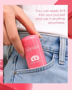 Portable and compact Julystar pink pocket blush stick being tucked into a denim jeans pocket