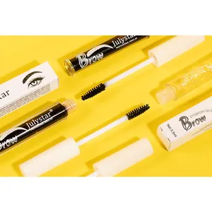 Close-up detail of Julystar waterproof eyebrow glue tubes and brushes on yellow background