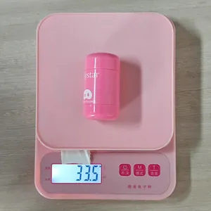 Detail view showing a pink pocket blush cream weighing 33.5 grams on a digital scale