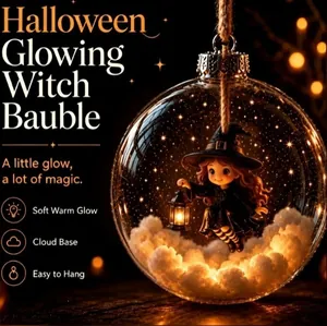 Detail of a Halloween glowing witch bauble with soft warm light and cloud base