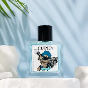 Close-up of CUPI Hypnosis blue perfume bottle on white stone platform with leaf shadows