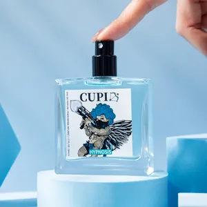 Close-up view of a blue Cupid pheromone perfume bottle displayed on modern geometric stands