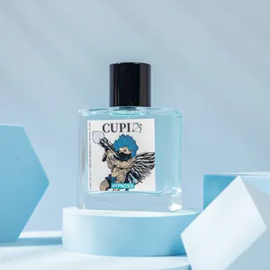 Close-up of Cupid blue perfume bottle with modern cherub illustration label on blue background