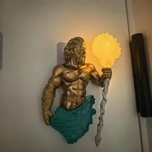 Poseidon sculpture wall lamp featuring a glowing shell torch in gold and teal