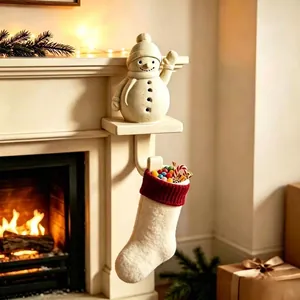 Gancho de calcetín navideño de muñeco de nieve en chimenea con calcetín festivo