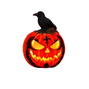 A glowing Halloween jack-o'-lantern ornament featuring a detailed black crow on top.