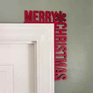 Detailed view of red wooden Merry Christmas corner decoration mounted on a white door frame