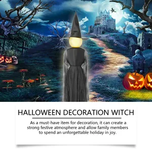 Spooky faceless Halloween witch figurine with glowing head set in a mystical graveyard