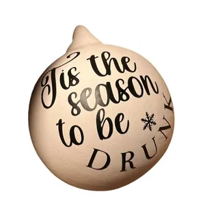 Detail of funny Christmas bauble with 'Tis the season to be drunk' text printed in black.