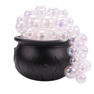 Close-up view of black Halloween witch cauldron with iridescent bubble decor.