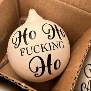 Close-up of a funny offensive Christmas bauble ornament with HO HO FUCKING HO text