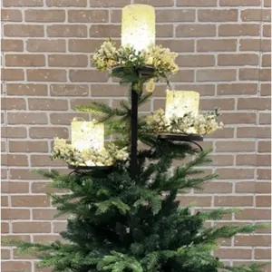Close-up of a black iron triple tree topper candle holder with festive floral decor