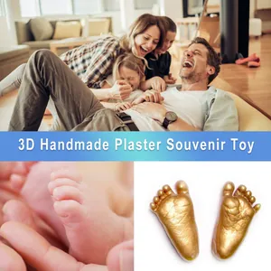 Detail of 3D handmade plaster souvenir showing baby foot casts and happy family