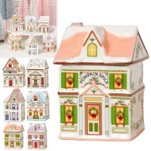 Set of 6 decorative ceramic spice jars shaped like festive Christmas village houses.