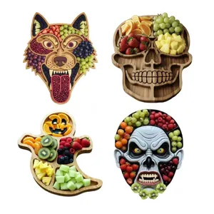 Detailed view of four Halloween-themed charcuterie boards in monster and skull shapes