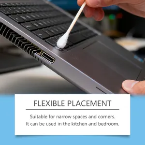 Macro view of double-headed cotton swab cleaning laptop keyboard crevices