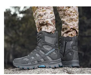 Detailed side view of grey men's tactical boots with blue accents and side zippers outdoors