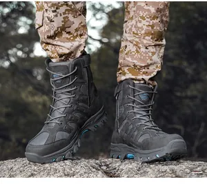 Grey high-top tactical combat boots with rugged sole on outdoor rock surface