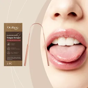 Close-up of rose gold stainless steel tongue scraper with oral hygiene packaging.