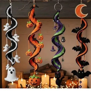 Macro view of four colorful crochet spiral Halloween decorations with ghosts and pumpkins