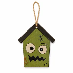 Detailed macro shot of a green wooden Halloween house ornament with a quirky monster face