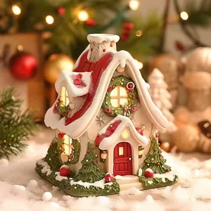 Close-up of cozy Christmas house incense burner with snowy roof and festive wreaths