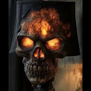 Close-up of gothic lava stone skull lamp with glowing internal amber light effects