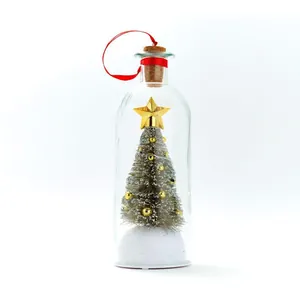 Close-up van een miniatuur kerstboom in een glazen fles met gouden ster en kurken stop