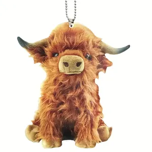 Detailed close-up of a shaggy brown highland cow ornament with a silver ball chain.