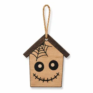 Close-up of Halloween wooden house ornament featuring spider web and scary face pattern