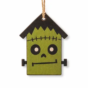 Detailed macro view of a wooden Frankenstein house ornament for Halloween decor.