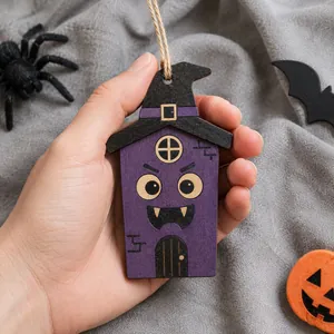 Detail of a purple wooden Halloween house ornament with a funny face and witch hat