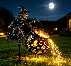 Detailed view of Halloween witch cauldron garden light with flowing LED fairy lights